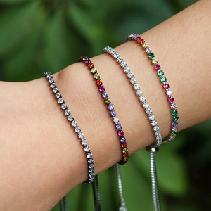 Wrist close-up of colorful zircon tennis bracelets with adjustable pull chains