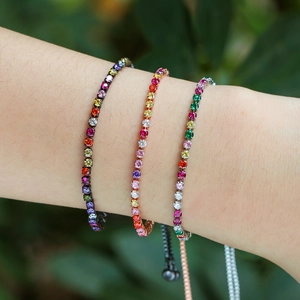 Detailed view of rainbow zircon tennis bracelets in black, rose gold, and silver finishes