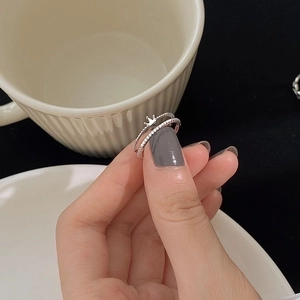 Minimalist double layer crown open ring in silver finish worn on finger for women