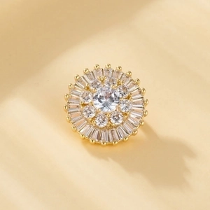 Macro view of gold-plated sunflower brooch featuring zircon clusters and sparkling inlay