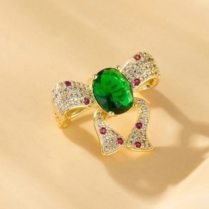 Detailed view of butterfly bow ring with gold plating and colorful zircons