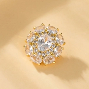 Detailed macro view of a gold-plated flower brooch with oval zircon crystal petals