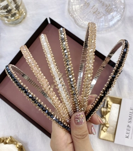 Close-up of sparkling crystal-beaded headbands in multiple colors on a gift box