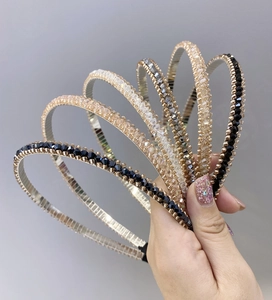 Close-up of sparkling crystal rhinestones on slim metal headbands in multiple colors