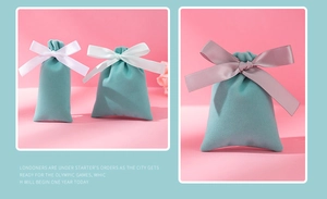Detail of plush velvet drawstring jewelry bags in mint green with elegant satin ribbons