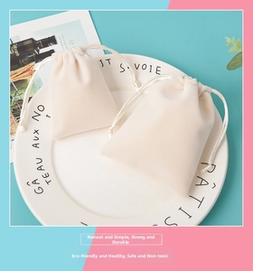 Macro detail of cream velvet drawstring pouches for premium jewelry storage