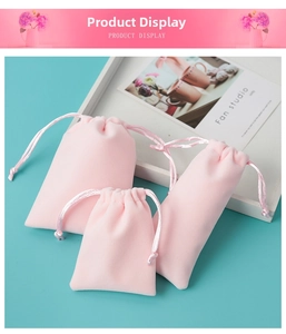 Three sizes of pink plush drawstring bags for jewelry storage on a blue background