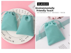 Close-up of mint green velvet drawstring jewelry pouch on a white plate and magazine