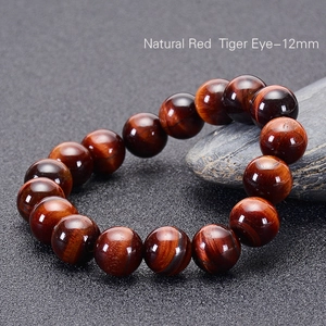 Macro detail of 12mm natural red tiger eye beads with silk luster and cat-eye effect