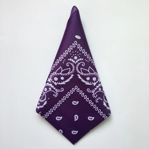 Detailed view of a folded purple paisley cotton bandana with classic hip-hop patterns
