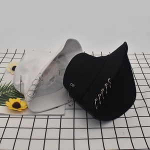 Detail view of cotton bucket hat with metal rings, safety pin, and 100% cotton size label