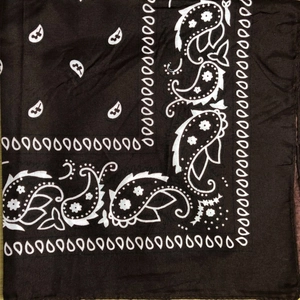 Close-up of black paisley pattern on polyester bandana fabric texture and details