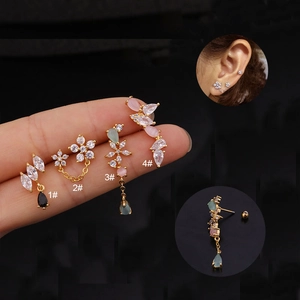 Detailed macro view of gold plated screw-back floral studs with colorful zirconia stones