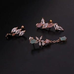 Detail of rose gold earrings with white pink and blue teardrop zircon stones