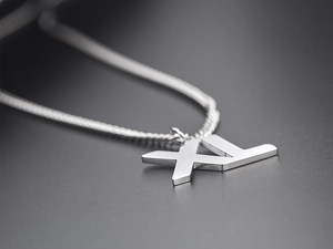 Macro view of silver stainless steel necklace with a large XL letter pendant detail