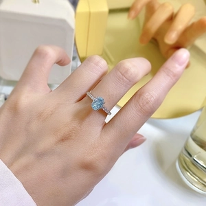 925 silver ring with oval light blue zircon and micro-paved diamonds on finger