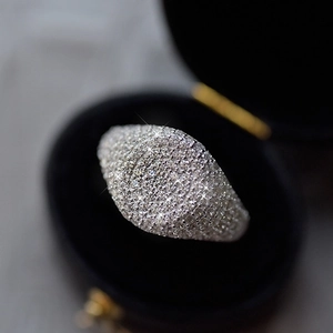 Macro shot of wide S925 silver ring band with pavé micro-set cubic zirconia in black box
