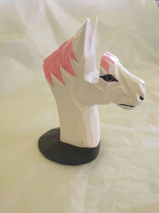 Detailed side view of horse head wooden glasses stand with pink mane and geometric carving