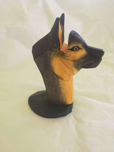 Hand-carved wooden German Shepherd bust eyeglass holder on a black round base stand