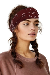 Close-up of a bohemian style burgundy headband with white paisley print on a model
