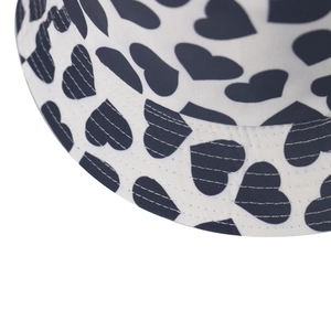 Close-up of heart print pattern and multi-row stitching on the brim of a bucket hat