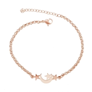 Detail of rose gold star and moon pendant bracelet with adjustable extension chain