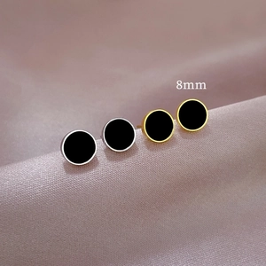 Minimalist 8mm titanium steel round earrings with black shell inlay on purple silk fabric