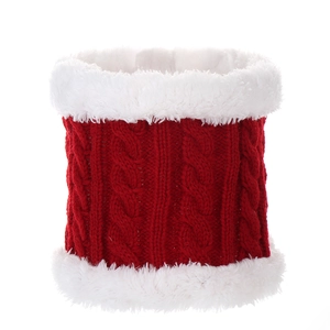 Macro detail of red knitted winter scarf with white faux fur trim and cable knit texture