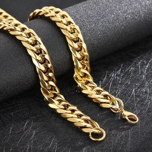 Macro shot of heavy gold Cuban link chain with a high-polish finish and lobster clasp