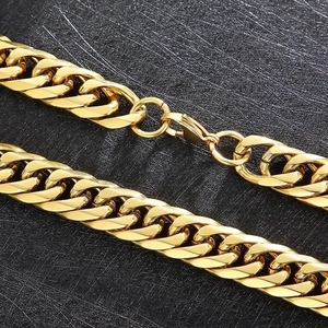 Macro detail of gold stainless steel cuban link chain with high-polish lobster clasp