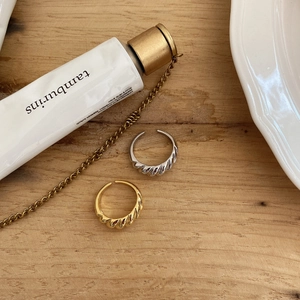 Flat lay of vintage twisted 925 sterling silver rings in gold and silver finishes