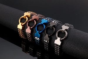 Detail view of woven stainless steel chain bracelets in five distinct metallic colors