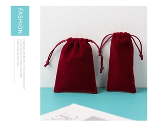 Detailed comparison of two sizes of burgundy velvet drawstring jewelry pouches