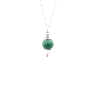 Close-up of green gemstone bead pendant on a delicate silver chain necklace