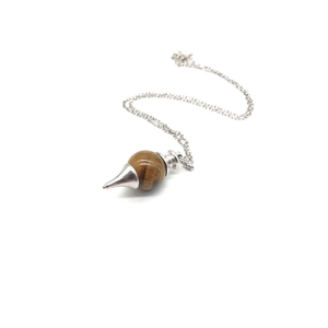Macro view of a brown tiger eye stone pendulum necklace with silver sword pattern base