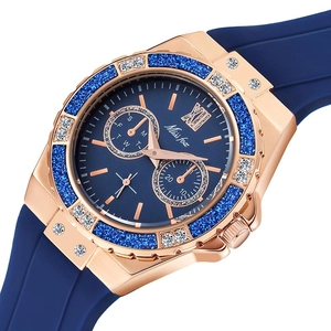 Macro view of rose gold bezel with sparkling blue glitter and crystals on luxury watch