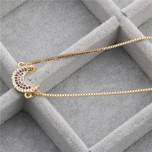 Adjustable gold box chain bracelet with crescent moon pendant and multi-color zircons