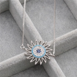 Detailed view of silver copper bracelet with blue and white zircon sunburst pendant