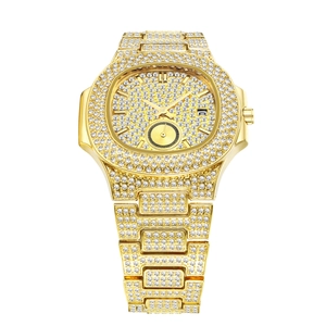Close-up of gold iced-out men's watch featuring a crystal octagonal bezel and date display