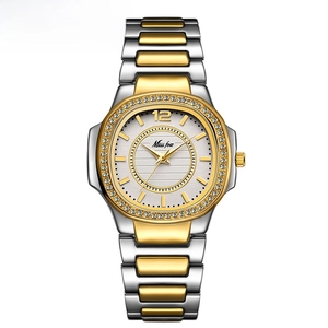 Elegant gold and silver tone women's watch featuring a crystal bezel and white dial