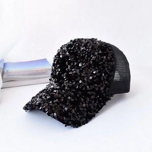 Close-up of black sequined baseball cap with breathable mesh texture and shiny finish