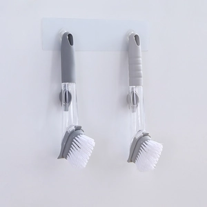 Long-handle liquid soap dispensing dish brush with grey handle and white nylon bristles