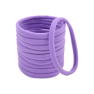 Set of thick purple nylon seamless hair ties with high elasticity on white background