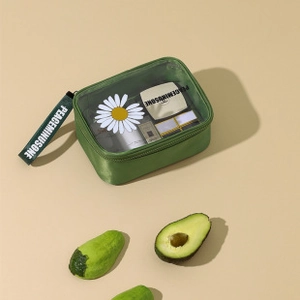 Detail view of large green travel makeup bag with daisy window and sturdy handle