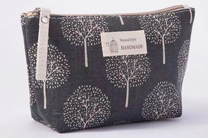 Detail of grey canvas makeup bag with tree print and Natural Style fabric label