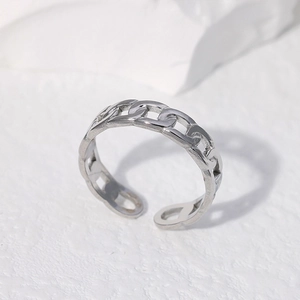 Minimalist silver chain link stainless steel open ring shown on a textured white stone