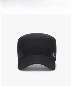 Close-up of black breathable mesh flat top cap with metal SS logo and reinforced stitching
