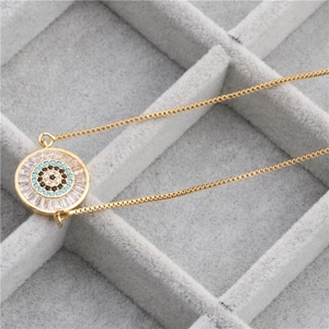 Golden box chain necklace featuring a turquoise evil eye pendant with cubic zirconia inlay
