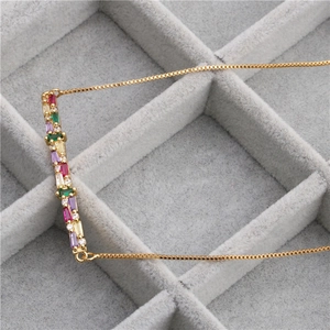 Elegant gold necklace with multi-colored rectangular zircon stones and a box chain