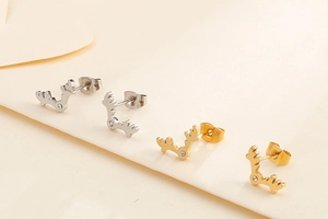 Macro view of elk antler stud earrings in gold and silver finish with tiny diamonds